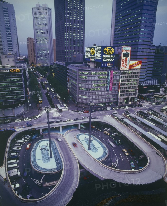 JAPAN, Honshu, Tokyo, Shinjuku with aerial view onto road intersection at night with skyscrapers behind