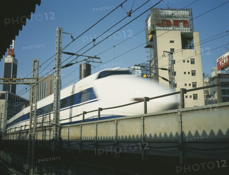 JAPAN, Honshu, Tokyo, Shinkansen Bullet Train speeding along raised railway line in the centre of Tokyo