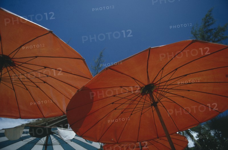 THIALAND, Phuket, Open red sun umbrellas seen from below against blue sky