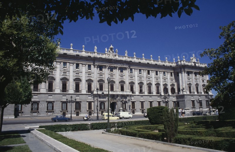 SPAIN, Madrid State, Madrid, The Royal Palace exterior framed by tree branches