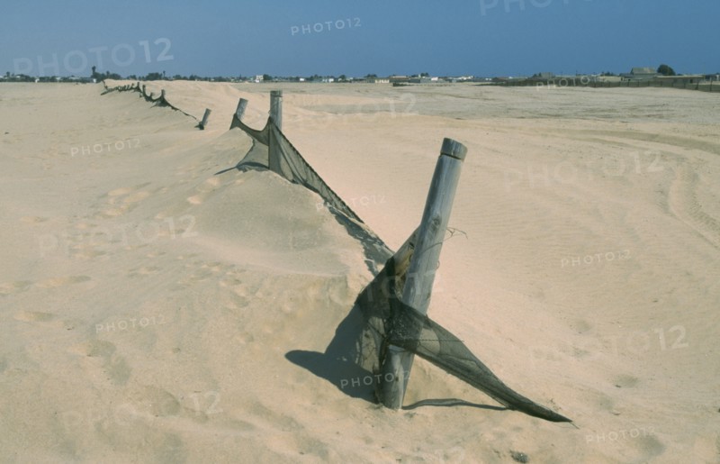 NAMIBIA, Swakopmund, Barrier to stop encroachment of sand dunes.