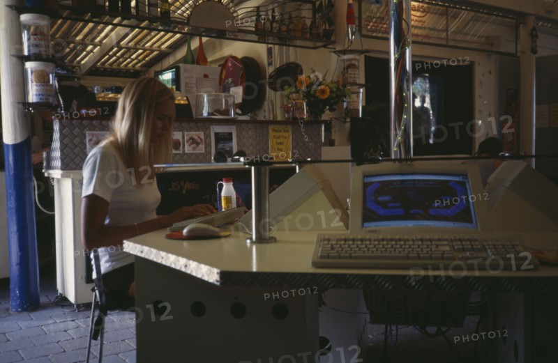 COMPUTERS , World Wide Web, Internet Cafe, AUSTRALIA Byron Bay. Internet cafe with girl at computer terminal.