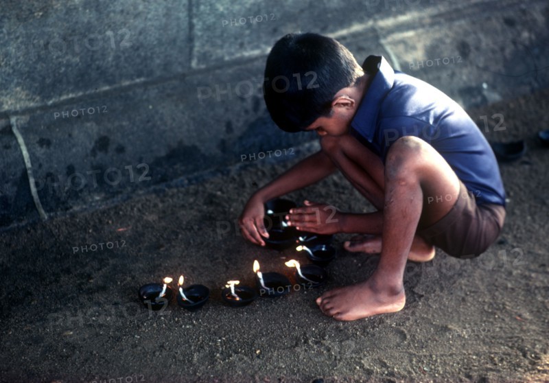 SRI LANKA, Religion, Young boy lighting lamps for Wessac