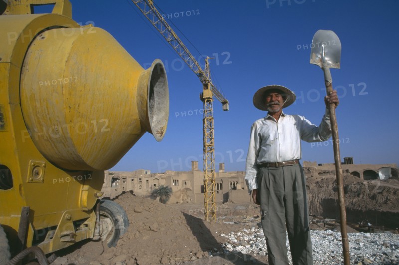 IRAN,   , Yazd, Construction worker on site Spade in hand
