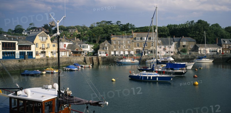 ENGLAND, Cornwall, Padstow , View across the harbour with fishing boats and yachts towards waterside buildings