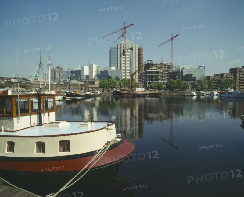 ENGLAND, London, "Docklands waterfront building development, moored boats "