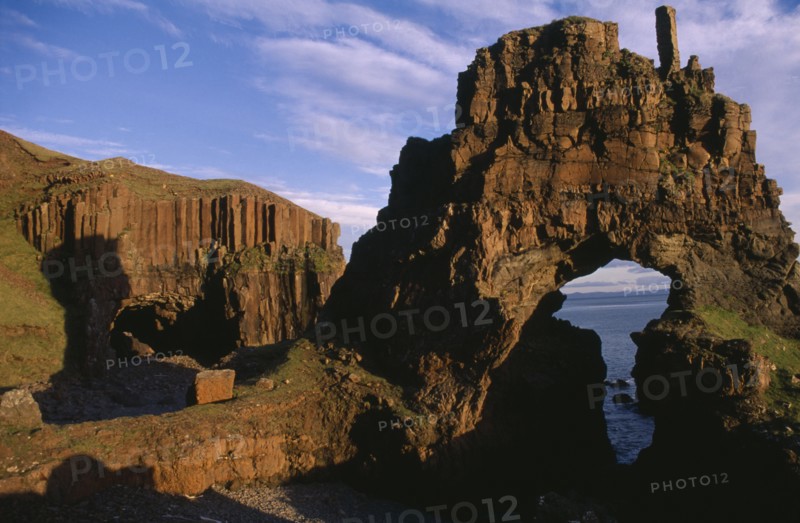 SCOTLAND, Isle of Mull, View through Carsaig arches formed from basalt rock and coastline