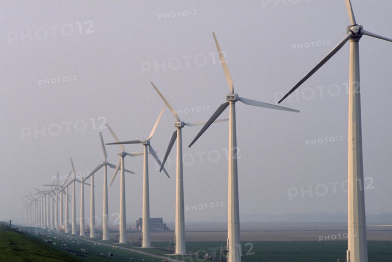 HOLLAND, Urk, Wind generators in a line in a misty landscape