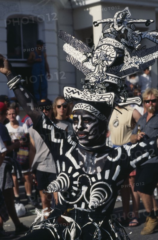ENGLAND, London, Notting Hill Carnival dancer dressed in a black and white costume and face paint