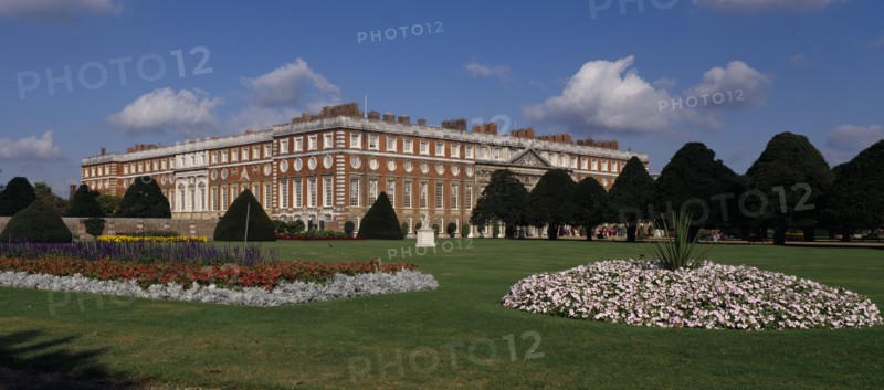 ENGLAND, London, Hampton Court Palace. General view seen across formal gardens