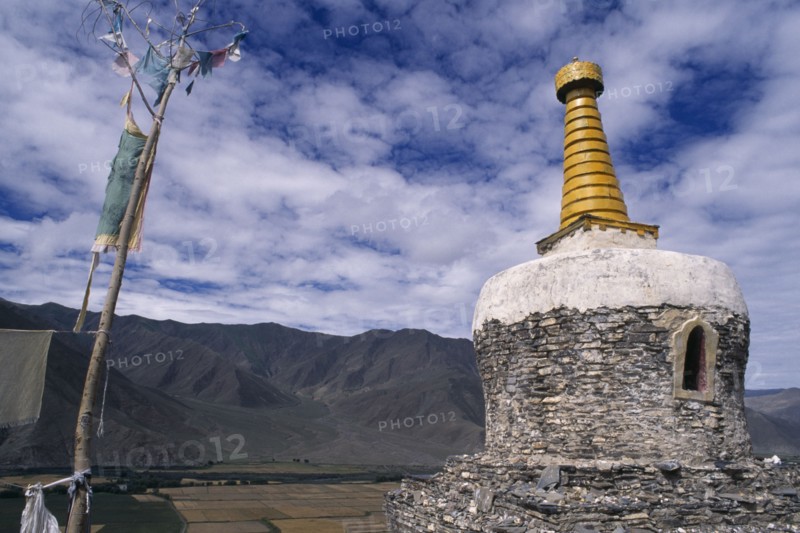 CHINA, Tibet, Yambu Lhakang Monastery, Chorten and prayer flags.