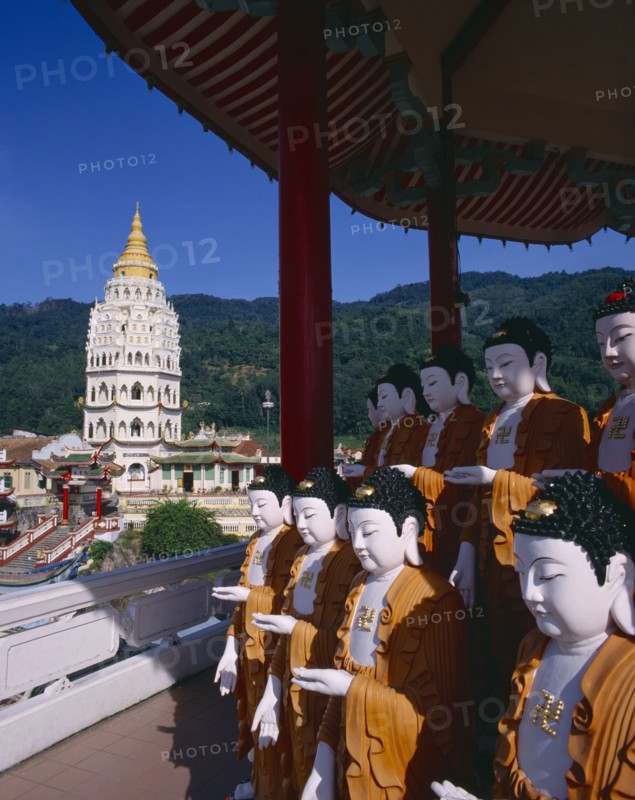 MALAYSIA, Penang, Kek Lok Si Temple, "Ban Po, the Pagoda of a Thousand Buddhas.  Seven tier pagoda with double row of standing buddha figures under canopy in the foreground. "