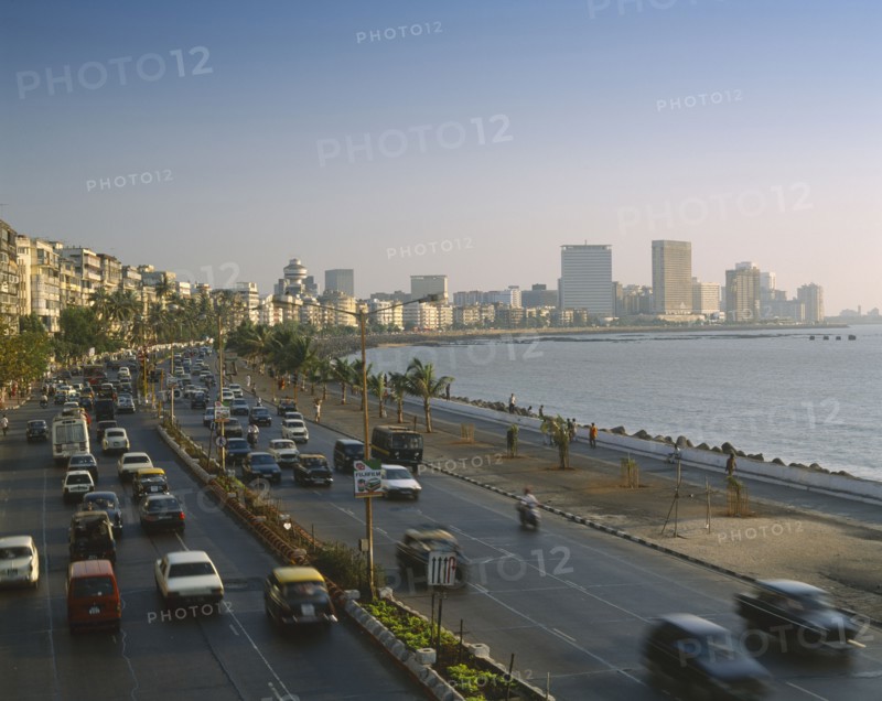 INDIA, Maharashtra, Bombay, "Marine Drive at dusk,cars on dual carriageway, skyscrapers beyond "
