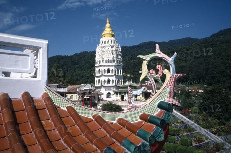 MALAYSIA, Penang, Kek Lok Si Temple, View over rooftop detail toward white tower with golden roof and spire