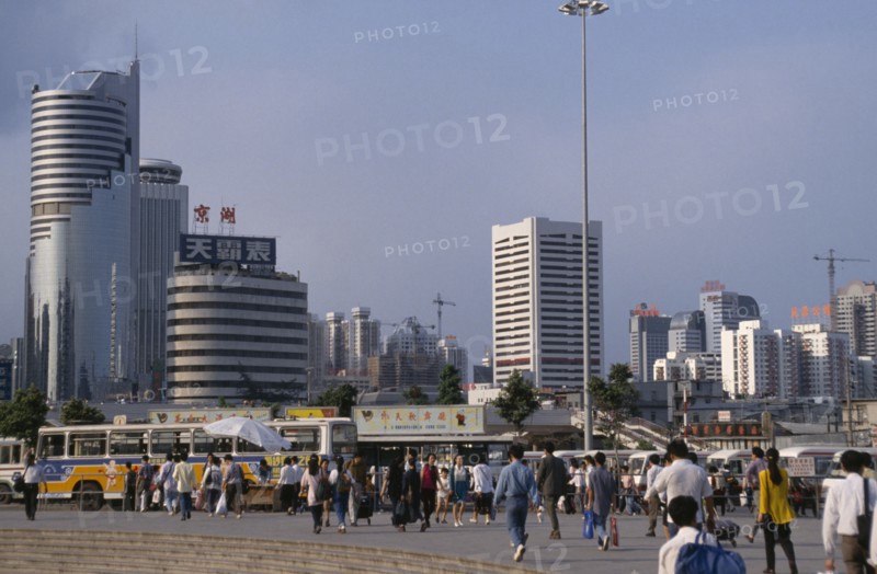 CHINA, Guangdong, Shenzhen, "Special Economic Zone, city buildings, buses and crowds of pedestrians."