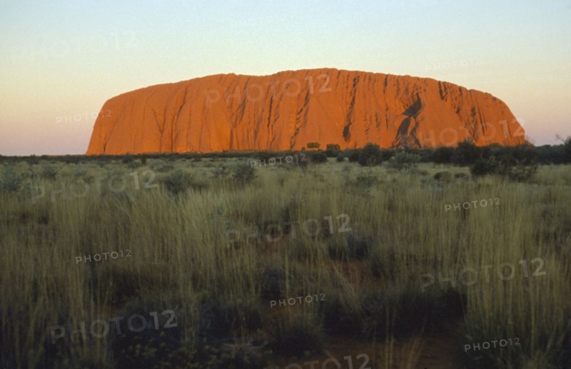 AUSTRALIA, Northern Territory, Uluru, Ayers Rock at sunset.