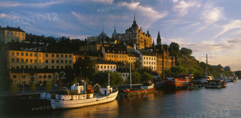 SWEDEN, Stockholm, Evening shot of the waterfront area with boats moored