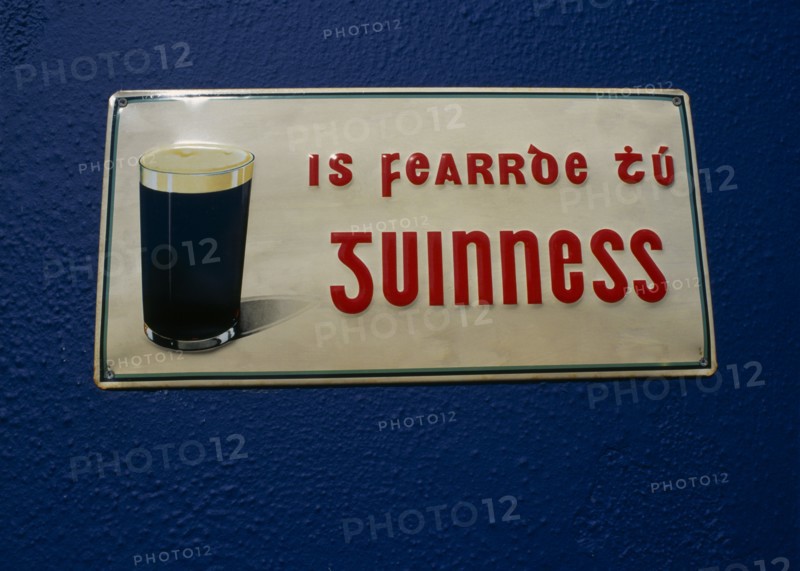 IRELAND, County Galway, Spiddal, Guinness sign written in Gaelic on Pub wall