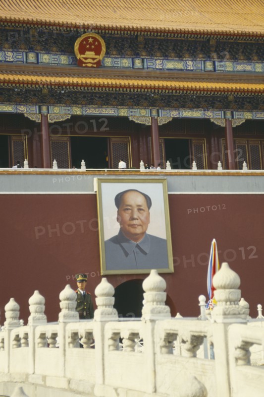 CHINA, Hebei, Beijing , Policeman standing under a picture of Chairman Mao