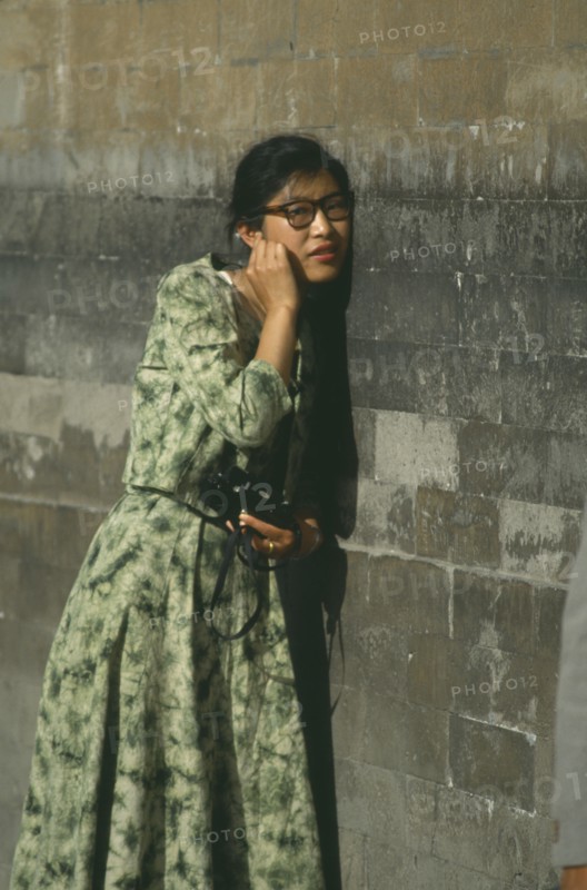 CHINA, Hebei, Beijing, Temple of Heaven.Woman standing next to wall