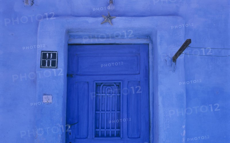 EGYPT, Eastern Desert, Hurghada, Detail of blue painted house and entrance with a starfish above a doorway in this Red Sea coastal town
