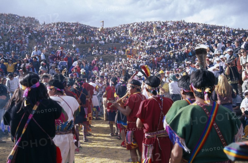 PERU, Cusco, Parade of musicians at Inti Raymi watched by crowds on the surrounding hillside.  Cuzco