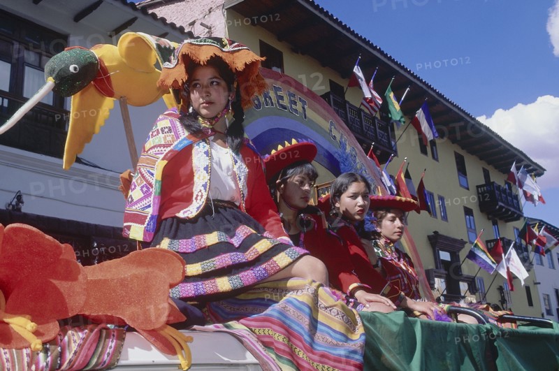 PERU, Cusco Department, Cusco, Women in tradtional costume on a processional float during Inti Raymi.