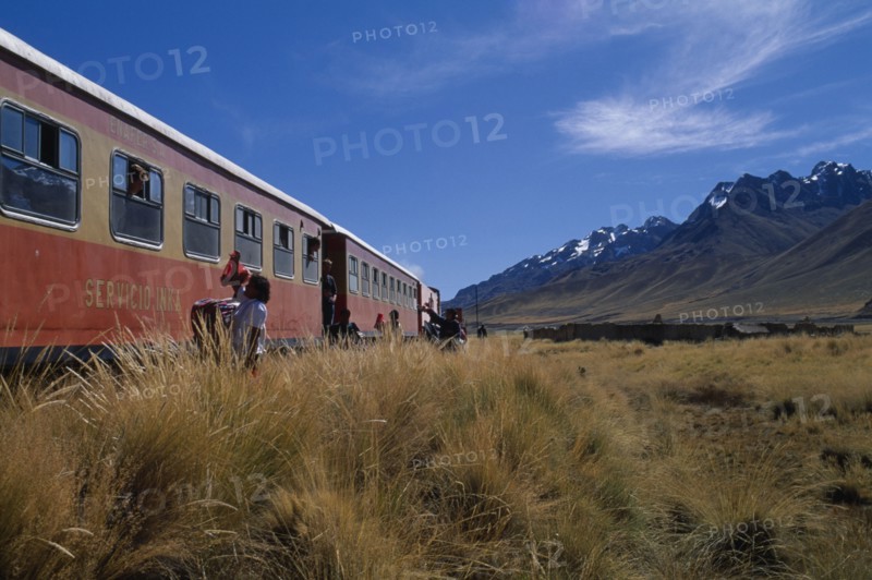 PERU, Puno Administrative Depatment, La Raya, Train stopped on the altiplano at the highest pass on the line between Puno to Cusco with people selling goods to passengers.