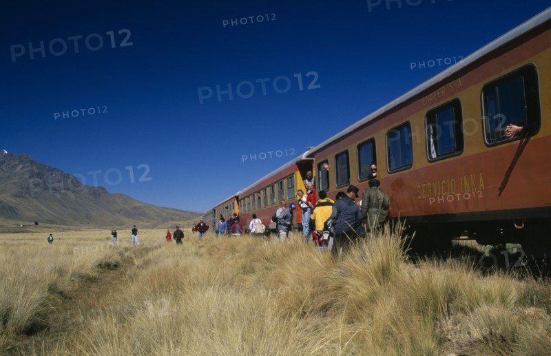 PERU, Puno Administrative Department, La Raya, Train stopped on the altiplano at the highest pass on the line between Puno to Cusco.  People disembarking.