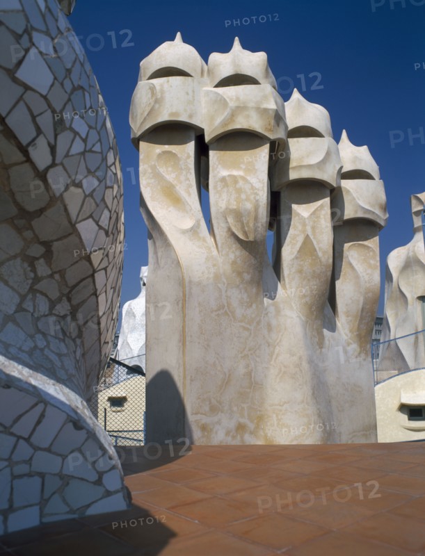 SPAIN, Catalonia, Barcelona, "La Pedrera.  Gaudi architecture, carved chimney pots on the rooftop."