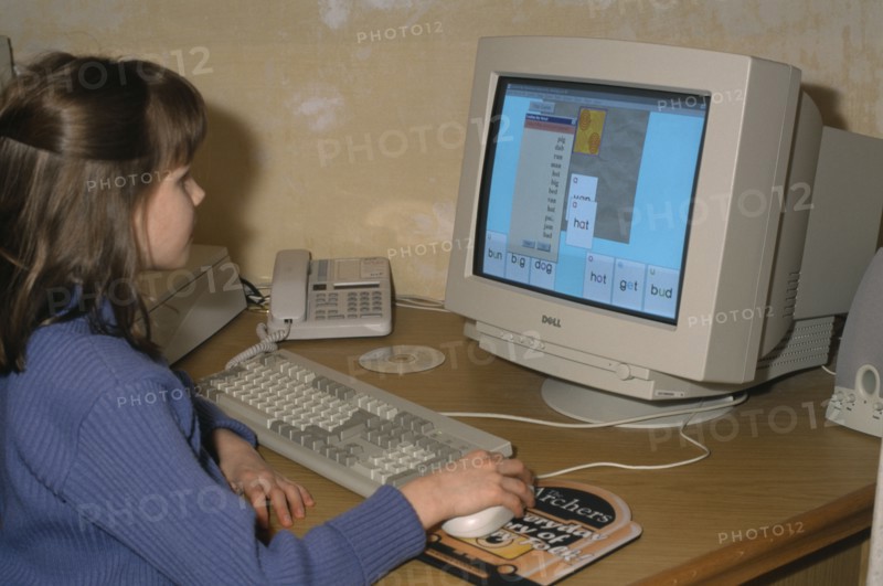 COMPUTER, School, Young girl using educational software on a home computer.