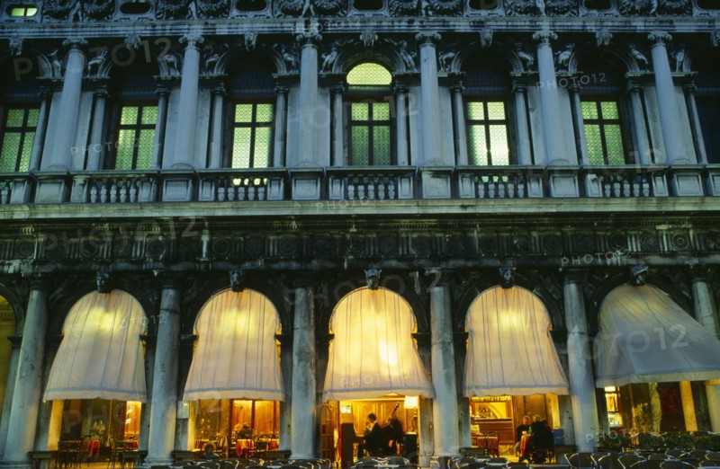 ITALY, Veneto, Venice, "Piazetta San Marco.  Café at night, detail of facade showing balcony, windows and lighted interior."