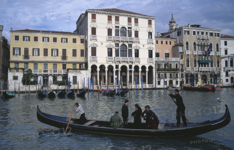 ITALY, Veneto, Venice, A Traghetti gondola taxi with passengers on the Grand Canal.