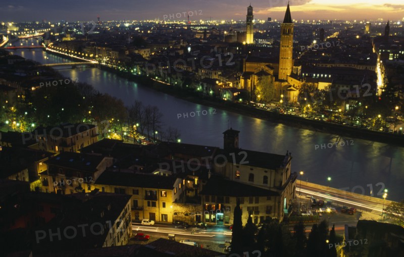 ITALY, Veneto, Verona, View over the Adige river and city at night.