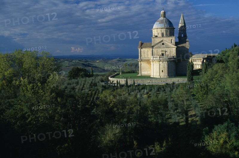 ITALY, Tuscany, Montepulciano, "Tempio di San Biagio, High Renaissance church with domed roof surrounded by trees."