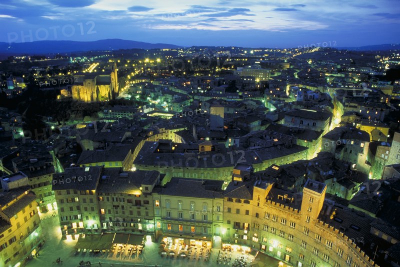 ITALY, Tuscany, Sienna, View across Siena at night.  The Piazza del Campo in the foreground.