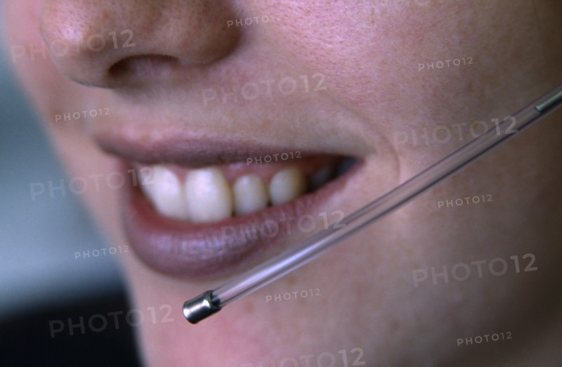 COMMUNICATIONS, Telephone, Telesales, Female telesales operator wearing a telephone head set.  Close up of lower half of face and mouthpiece.