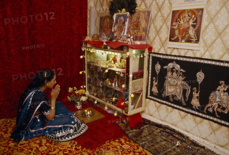 SOCIETY, Religion, Hinduism, England.  Girl at prayer at home during Dirwali.