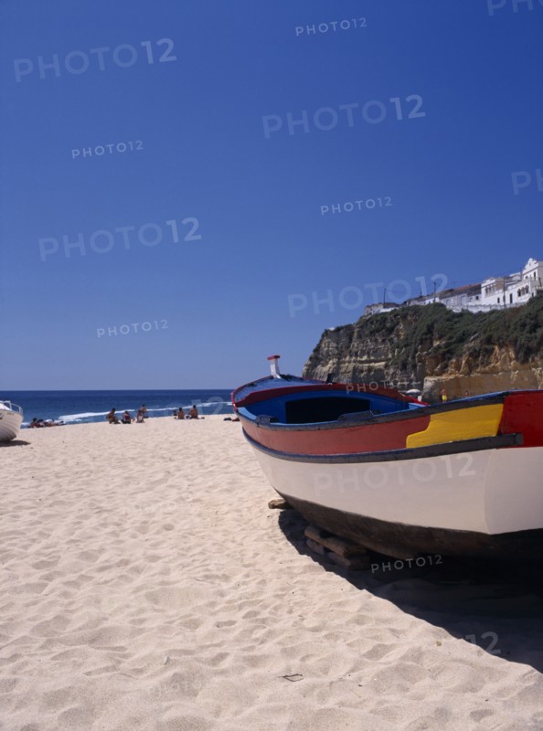 PORTUGAL, Algarve, Carvoeiro, Colourful fishing boat on the beach