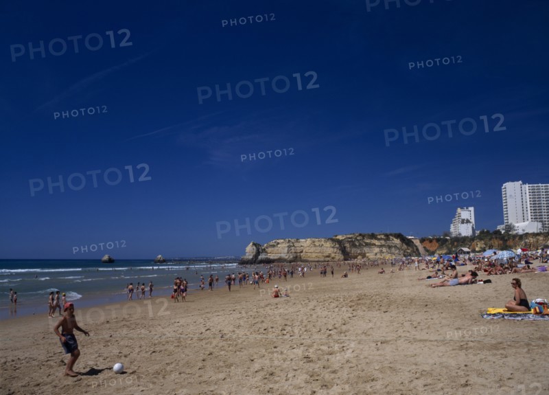 PORTUGAL, Algarve, Praia da Rocha, View along beach with children playing beach soccer
