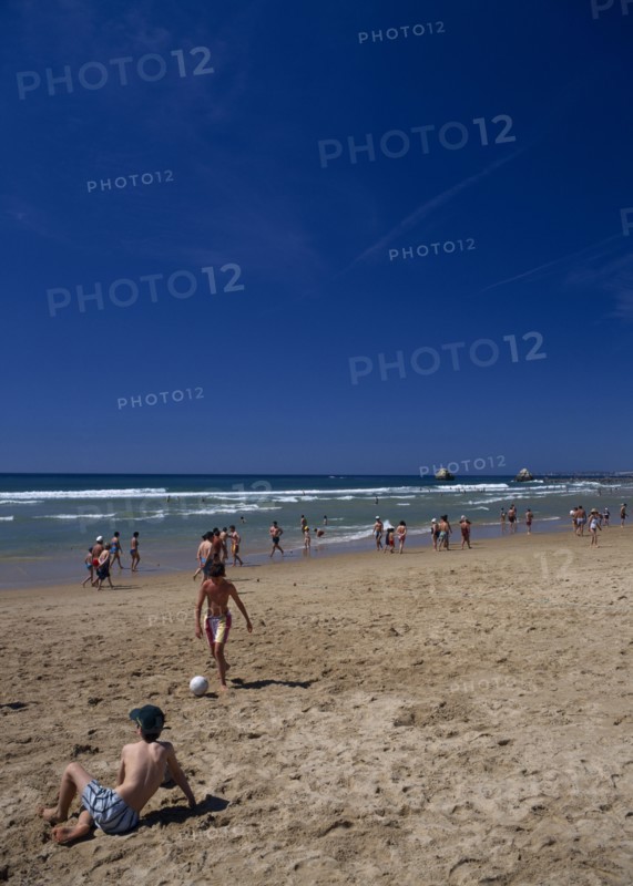PORTUGAL, Algarve, Praia da Rocha, View along beach with children playing beach soccer