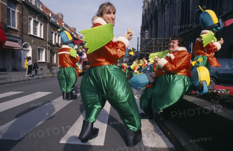 BELGIUM, Brabant, Brussels, "Woluwe St. Lambert, Spring Festival.  Group of people in green and orange Mardi Gras costumes."