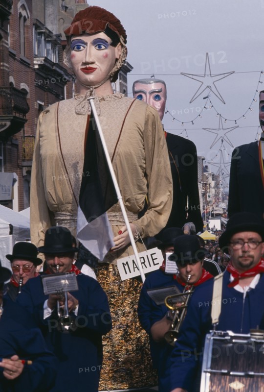 BELGIUM, Brabant, Brussels, "Woluwe St. Lambert, Spring Festival.  Parading bandsmen with giant figures in costume behind them."