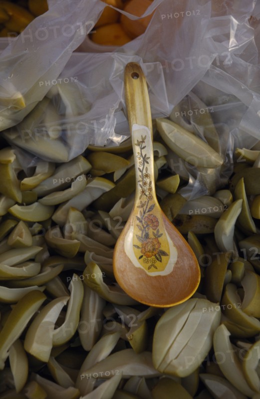 MALAYSIA, Kedah, Langkawi, Spoon in a bowl of green mangoes with vinegar on a stall at the Night Market in Cenang