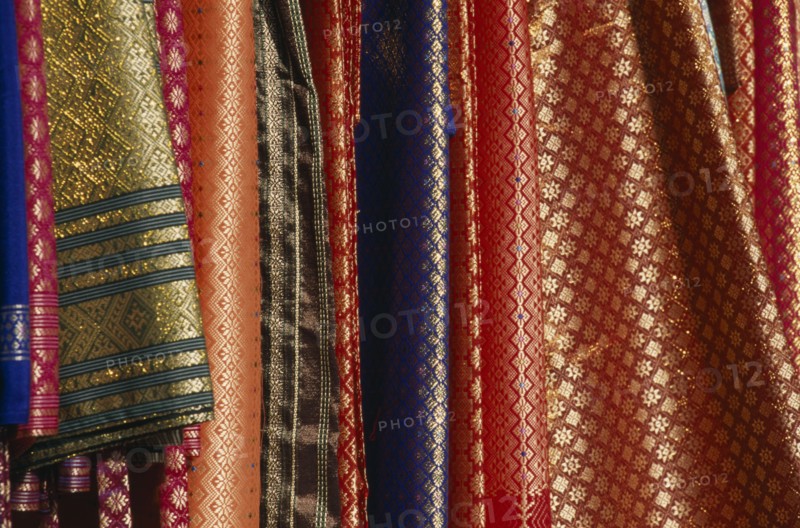 MALAYSIA, Kedah, Langkawi, Silk fabrics hanging outside a shop in Kuah old town