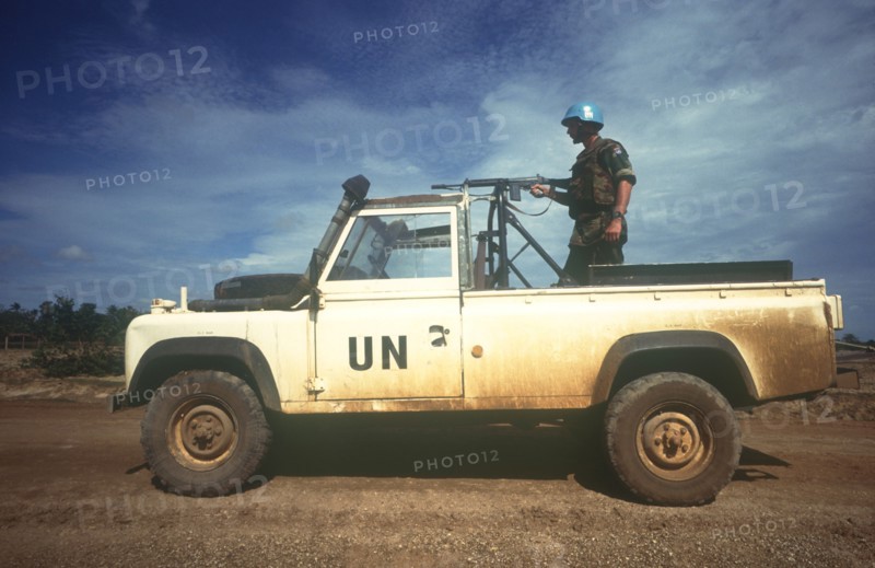 CAMBODIA, Thmar Pouk, Dutch made UN jeep with a soldier standing behind a mounted rifle in the back.