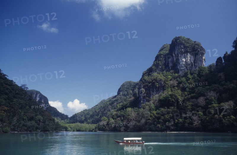 MALAYSIA, Kedah, Langkawi, Pulau Dayang Bunting island with a traditional covered boat used for transport between the islands