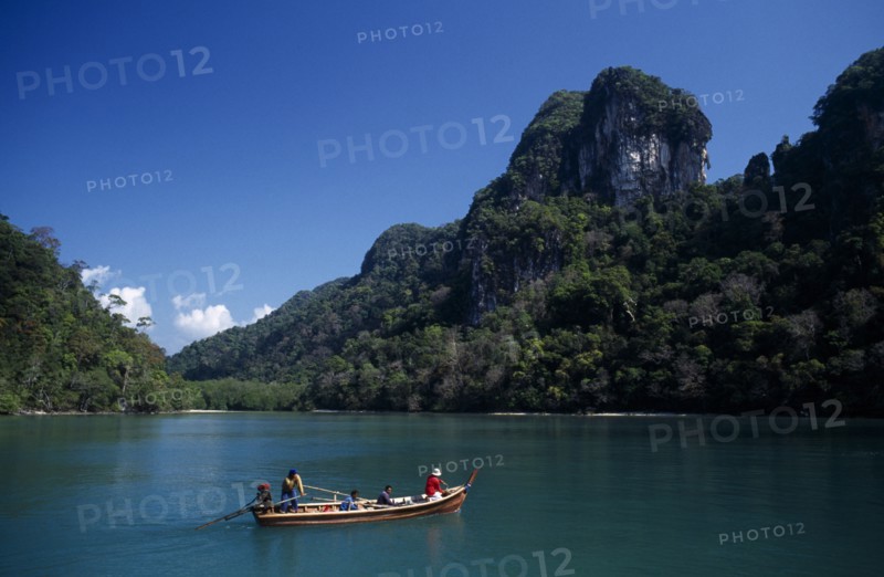 MALAYSIA, Kedah, Langkawi, Pulau Dayang Bunting island with hunters arriving in a traditional long boat