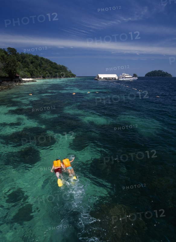 MALAYSIA, Kedah, Langkawi, Pulau Paya marine national park with two tourists snorkling above the coral reef