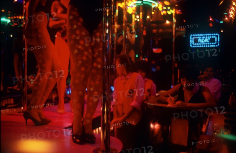 THAILAND, Bangkok, "Soi Cowboy Alley nightclub, view of stage and pole dancers. Sex Industry"